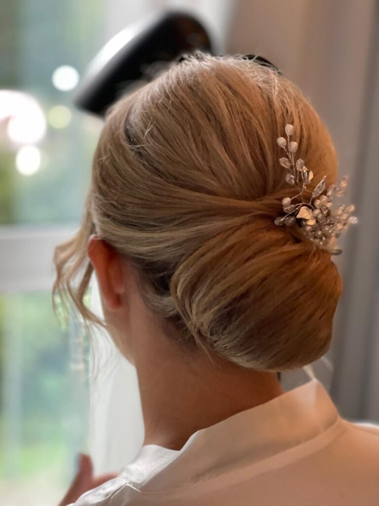Eleganter Chignon mit goldenem Blätter-Haarschmuck beim Getting Ready